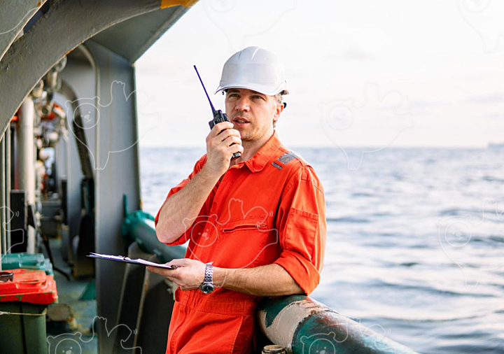 Deck Officer on deck of offshore vessel holds VHF walkie-talkie radio - NAVER OGQ 마켓